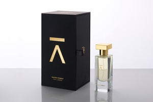 Studio photograph of a ‘Naked Forest’ perfume bottle by Azman Perfumes in collaboration with Prin Lomros, set against a white background. The bottle reflects a green, veggie, and mysterious aesthetic, highlighting elements such as iris, sandalwood, and mango.