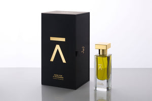 Studio photograph of a ‘Song For A Wanderer’ perfume bottle by Azman Perfumes in collaboration with Chris Maurice, set against a white background. The bottle reflects a green yellow, fresh, and mysterious aesthetic, highlighting elements such as smoke, wet land, jasmine, bergamot and oud.