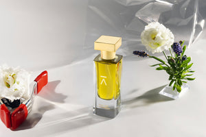 Studio photograph of a ‘Song For A Wanderer’ perfume bottle by Azman Perfumes in collaboration with Chris Maurice, set against a white background. The bottle reflects a green yellow, fresh, and mysterious aesthetic, highlighting elements such as smoke, wet land, jasmine, bergamot and oud.